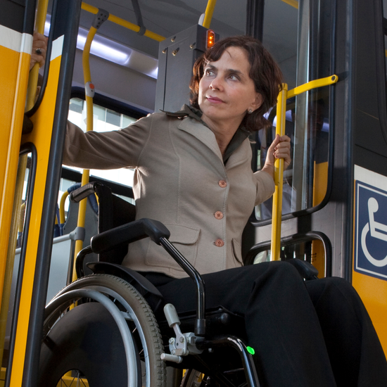 A photo of a person in a wheelchair using the bus