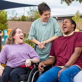 A photo of three students laughing