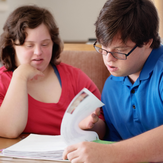 A photo of two people studying