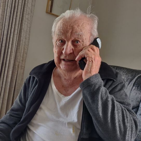 A photo of Walter talking on the phone. 
