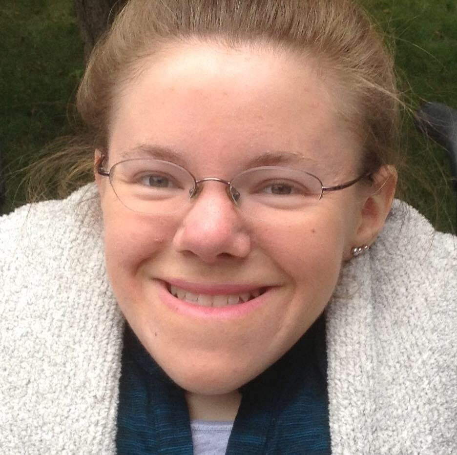A headshot photograph of Joanna smiling at the camera.