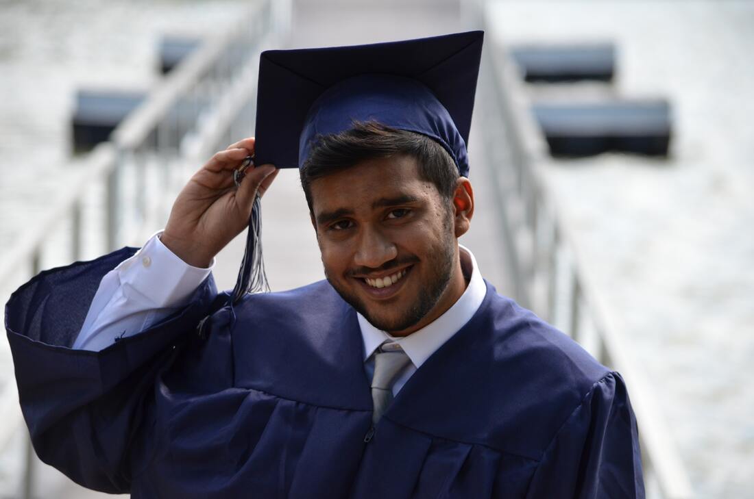 A young person in a graduation cap and gown.