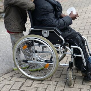 A photograph of a person using a wheelchair 